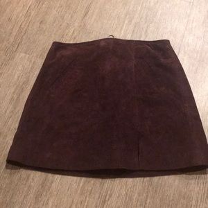 Maroon suede mini skirt with a slit detail